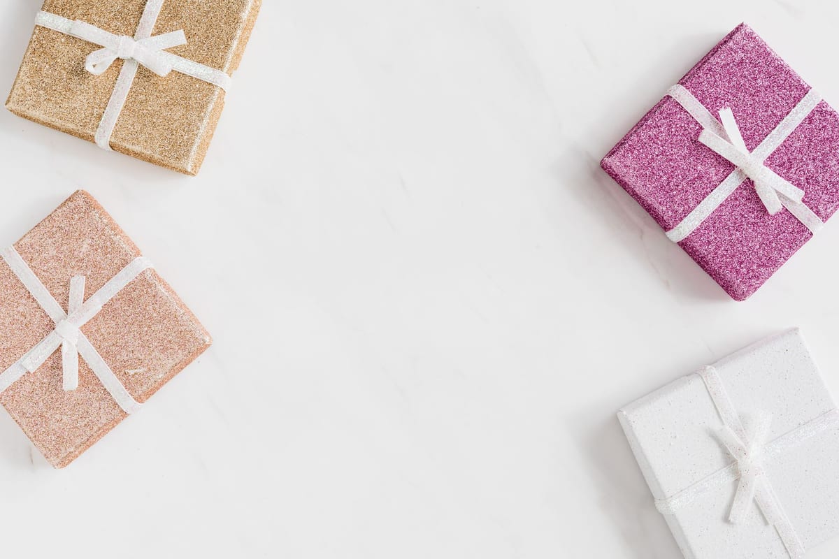 A few small cheerful wrapped gifts with ribbons