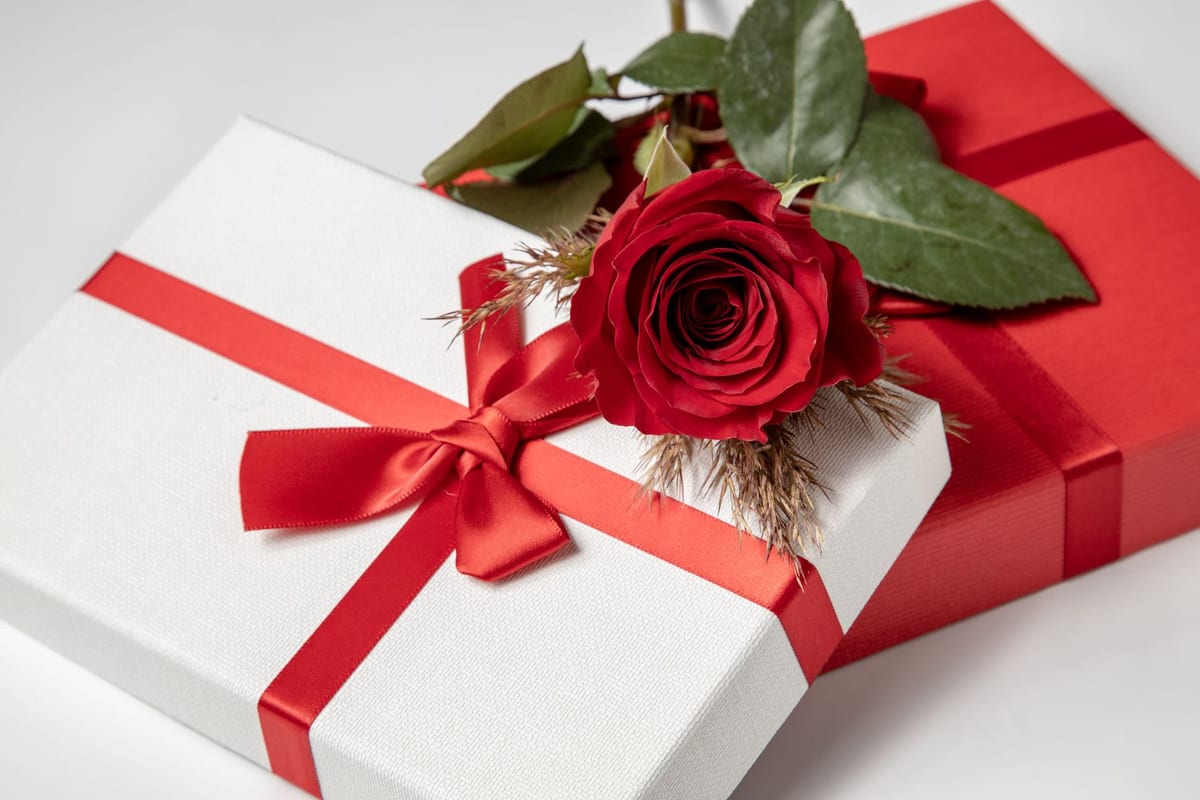 A romantic gift for a wife with roses and an elegant wrapped present