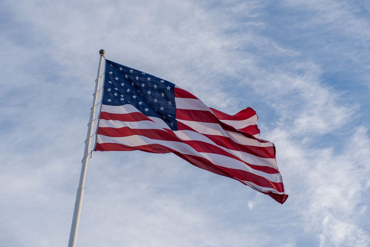 An American flag waving against a blue sky